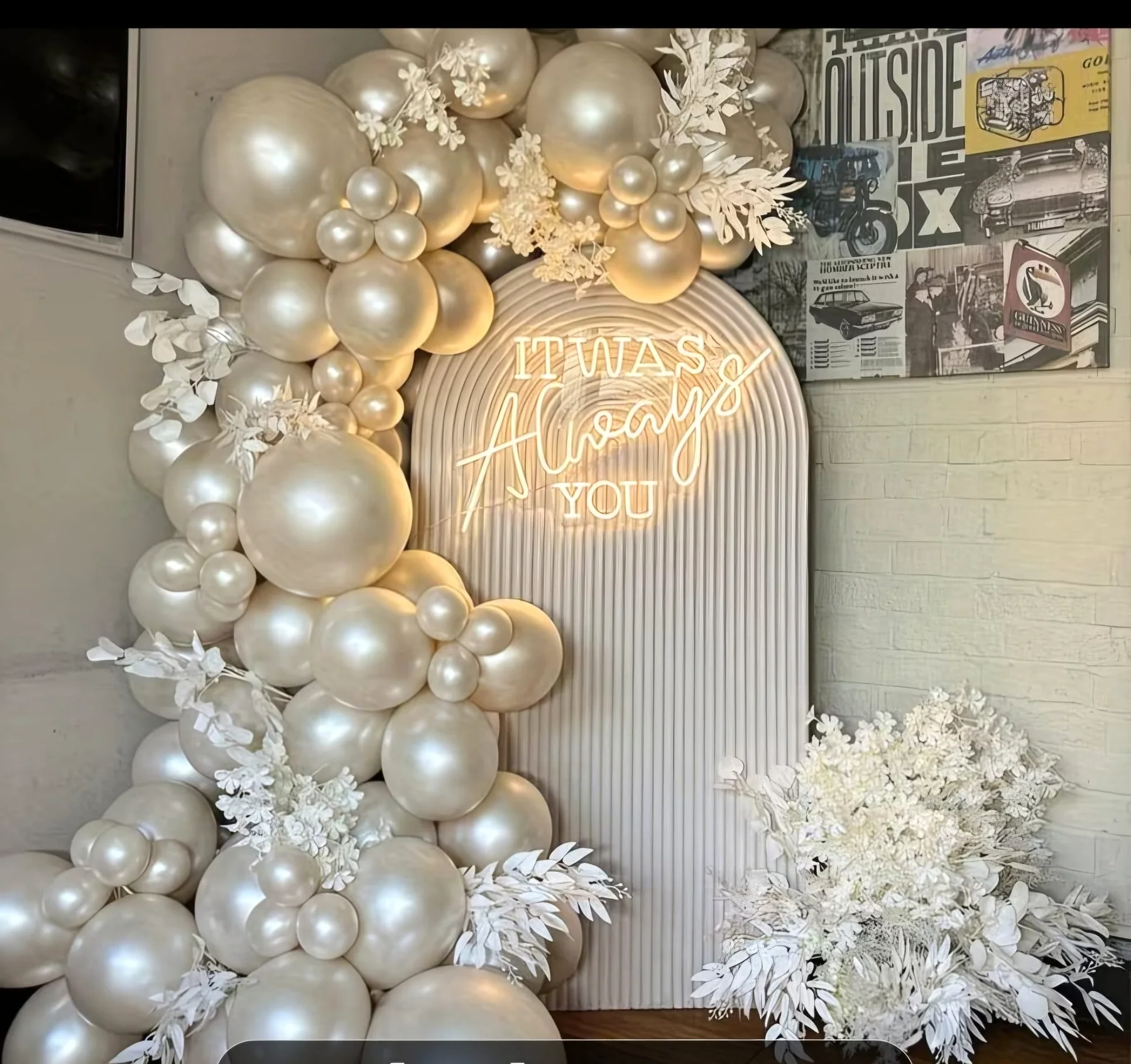 Cream balloon installation with an arched always you photo backdrop