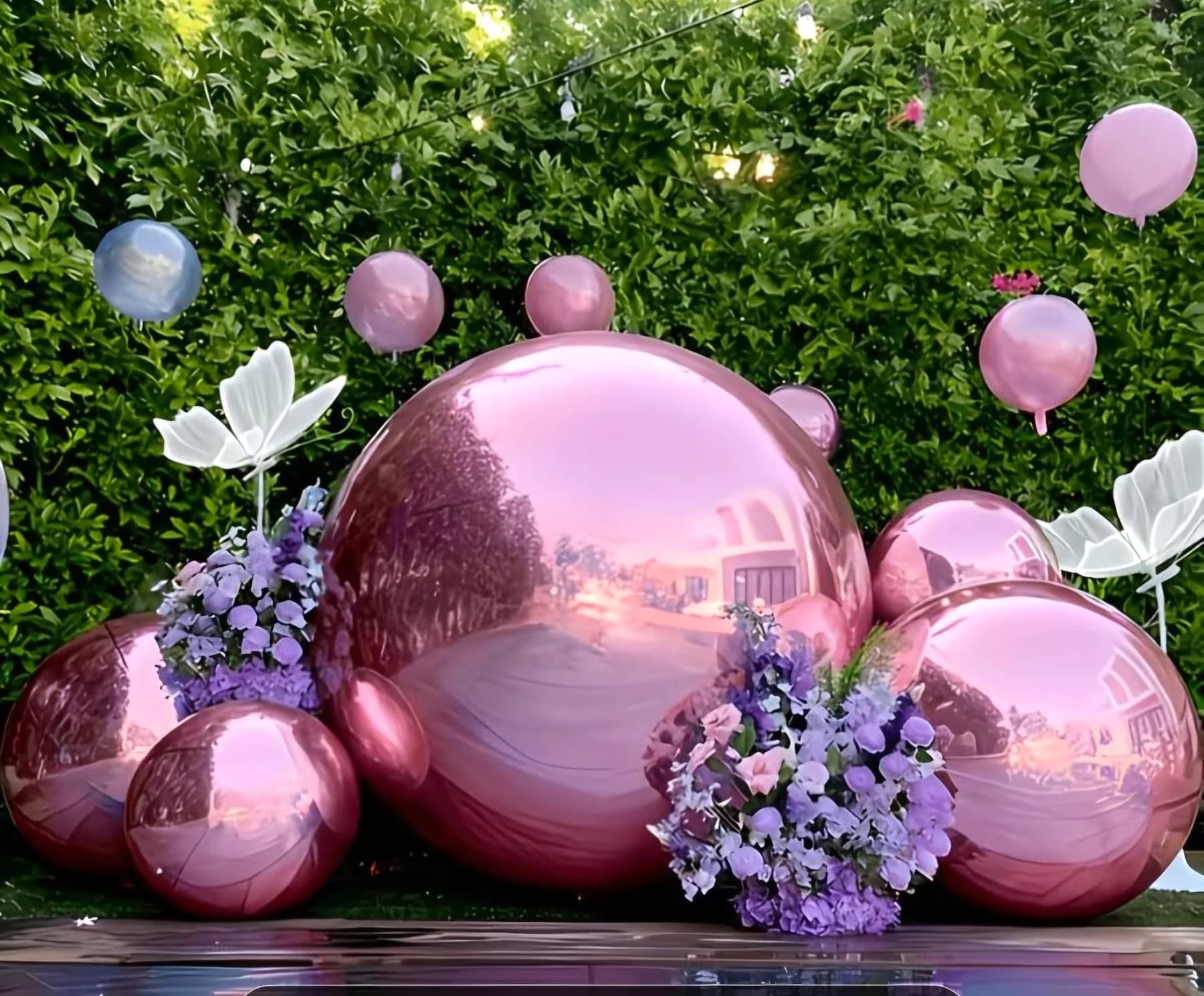 Pink balloon arrangement with floral details for a celebration backdrop