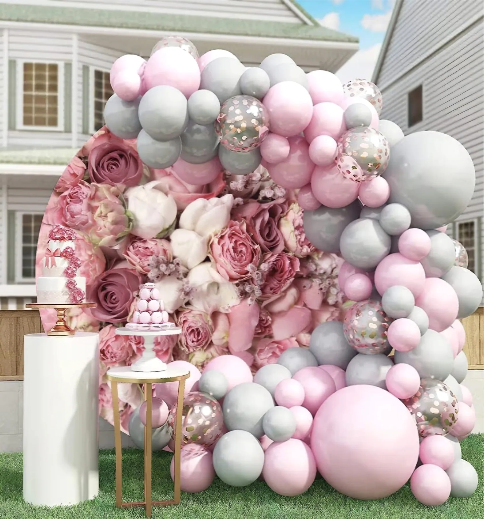 Pink and white celebration backdrop with balloons and floral accents